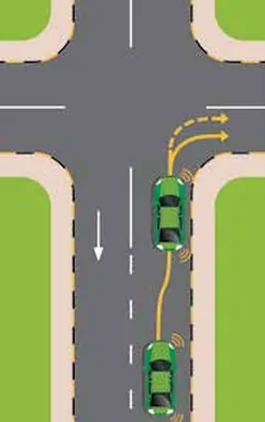 Green car approaching a junction and turning right, positioned at the right edge
