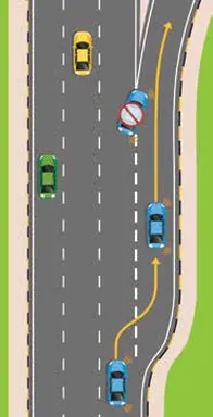 Motorway exit with a blue car in the right lane moving onto the slip road