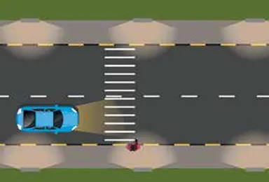 Night: car approaching a zebra crossing on a lit street