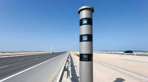 Speed camera post beside a straight desert highway