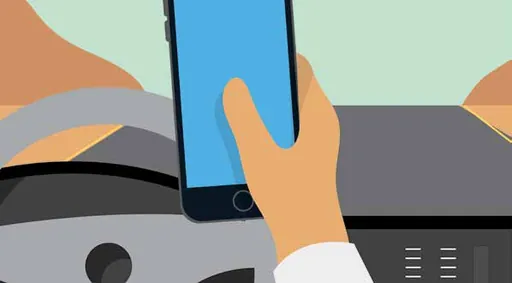Hand holding a mobile phone above a car dashboard while driving